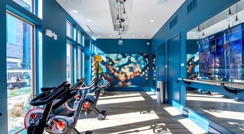 Fitness center with cycling bikes and mirrors at Lumeo at Tryon Park Apartments, North Carolina, 28262