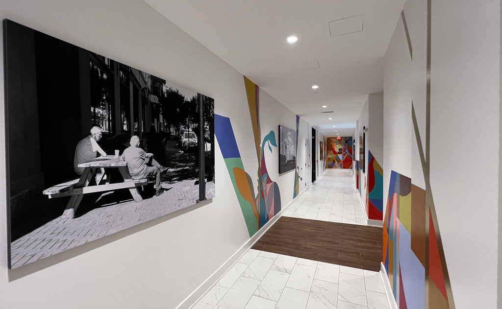 View Down a Hallway and Colorful Mural Art on the  at Link Apartments 4th Street in Winston-Salem, North Carolina