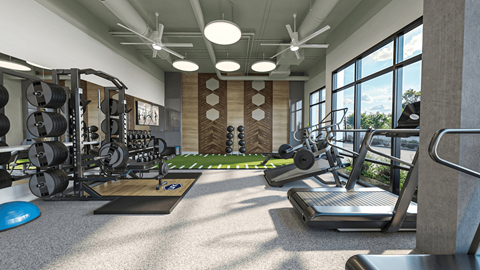 a gym with weights and other exercise equipment in a room with windows at Link Apartments® NoDa 36th Apartments, Charlotte, North Carolina