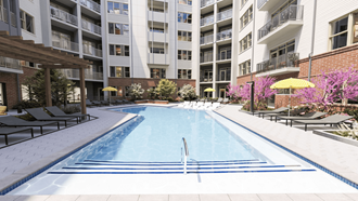 an outdoor pool with an apartment building in the background