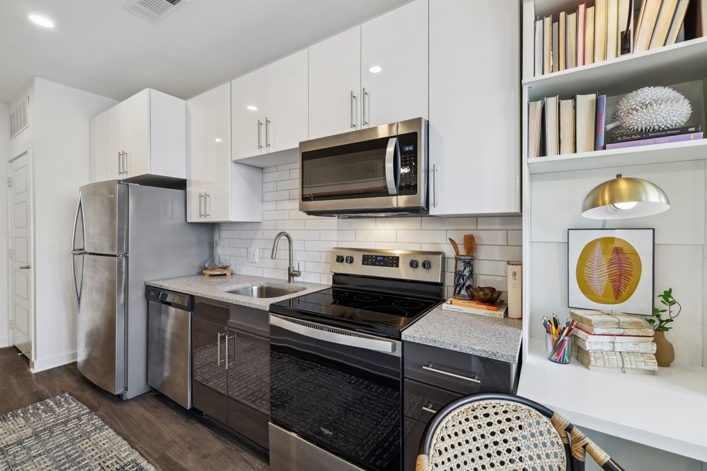 a kitchen with stainless steel appliances and white cabinets
