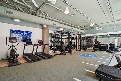 the gym at the landing at pullman apartments at Link Apartments® NoDa 36th, North Carolina