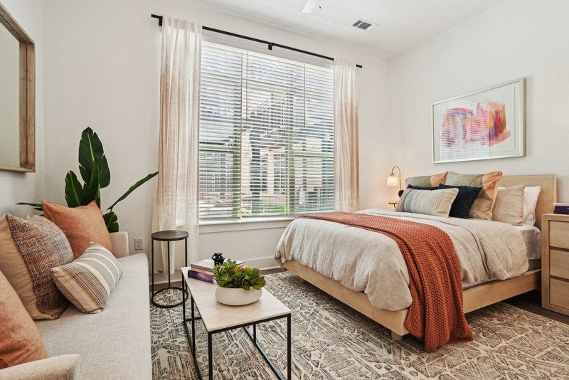 a bedroom with a bed and a large window at Link Apartments® NoDa 36th, Charlotte, North Carolina