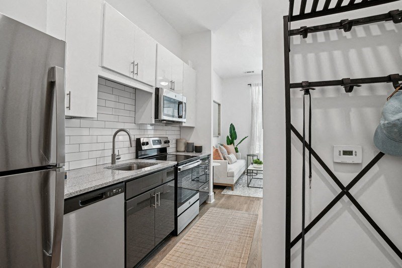 an apartment kitchen with stainless steel appliances and white cabinets at Link Apartments® NoDa 36th, Charlotte, NC, 28206