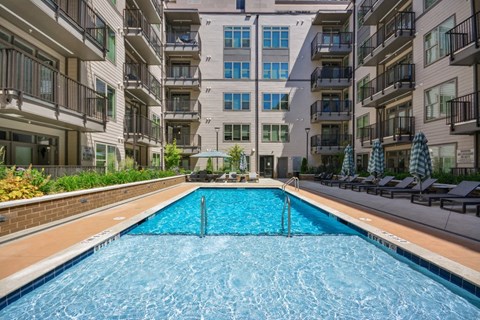 a swimming pool in the middle of an apartment building at Link Apartments® 4th Street, Winston-Salem, NC