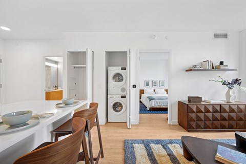 A modern kitchen with a dining table and chairs.