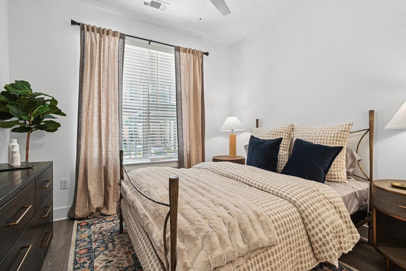 a bedroom with a bed and a large window at Link Apartments® NoDa 36th, Charlotte, 28206