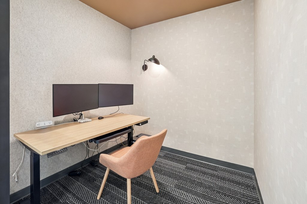 A desk with a computer and a chair in a room at Link Apartments® CYKEL Apartments, North Carolina, 28208