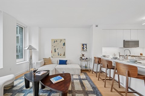 A modern living room with a white couch and a coffee table.