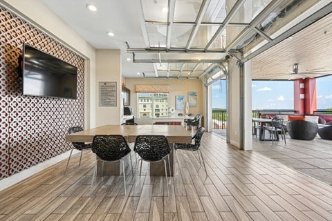 A conference room with a long table and chairs.