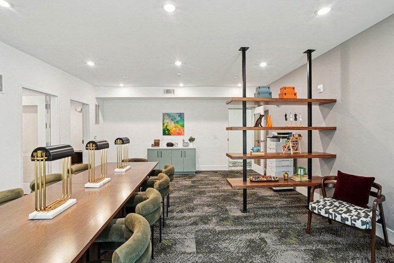 the living room of a house with a long wooden table and chairs at Link Apartments® NoDa 36th, Charlotte