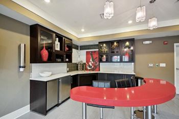 a modern kitchen with a red island in the middle