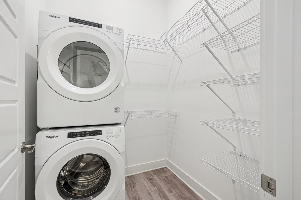 A laundry room with a washer and dryer stacked on top of each other at Link Apartments® CYKEL Apartments, Charlotte, NC