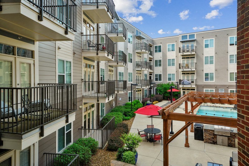 a view of an apartment building with a pool at Link Apartments® Brookstown, Winston Salem, NC
