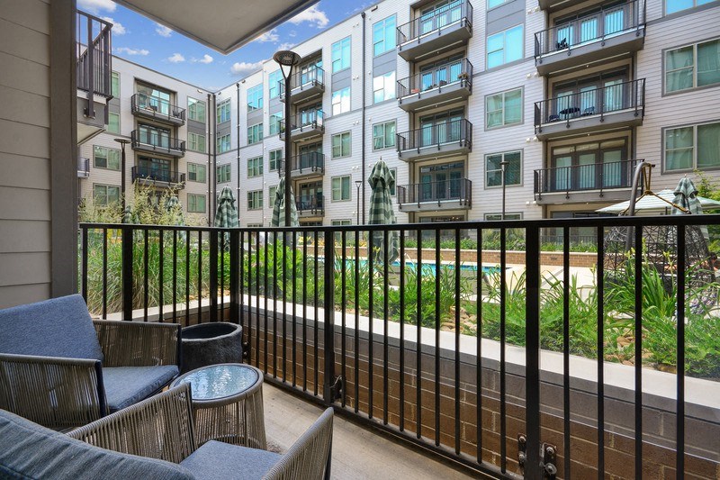 a balcony with a view of an apartment building and a pool at Link Apartments® 4th Street, Winston-Salem, NC, 27101