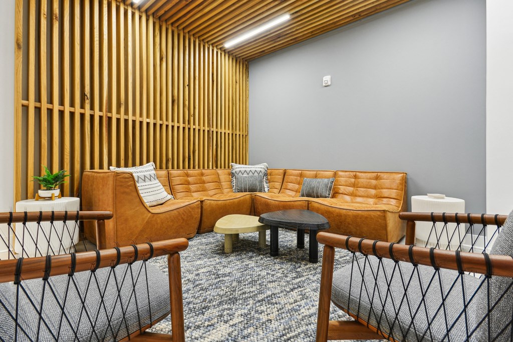 a living room with a couch and tables at Link Apartments® Calyx, North Carolina