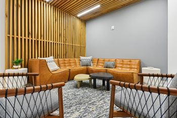 a living room with a couch and tables at Link Apartments® Calyx, Chapel Hill, NC