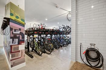 a group of bikes parked in a room with a rack of bikes at Link Apartments® Calyx, North Carolina