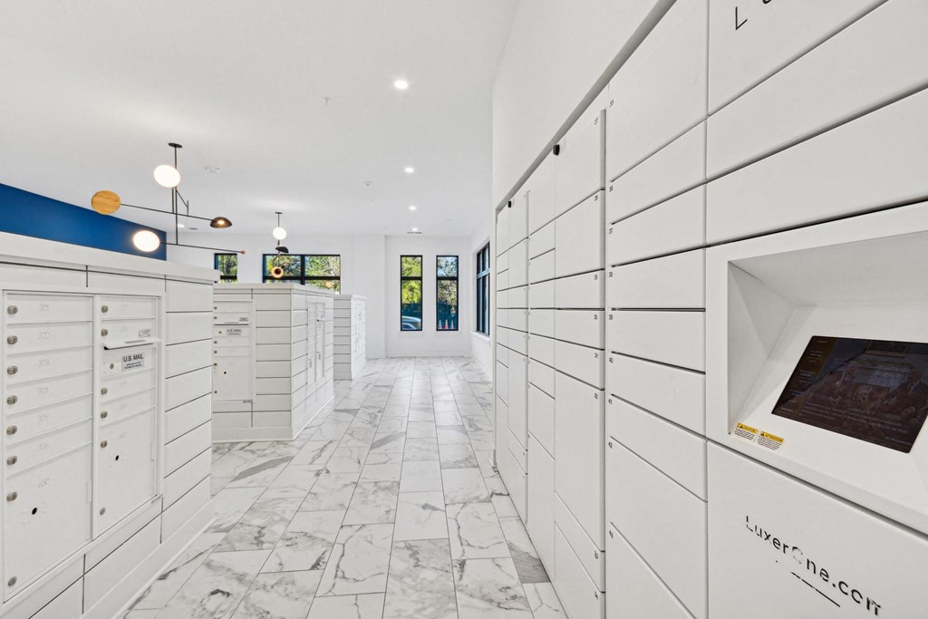 a large white closet with white cabinets and a marble floor at Link Apartments® Calyx, Chapel Hill, 27517