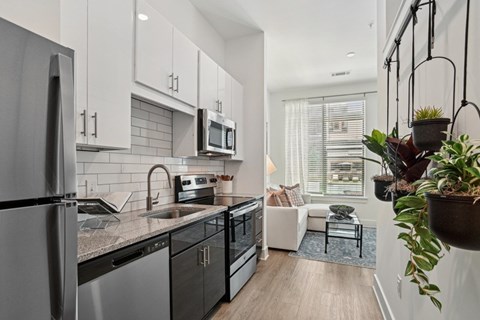 a kitchen with a sink and a refrigerator and a microwave at Link Apartments® NoDa 36th, Charlotte, 28206