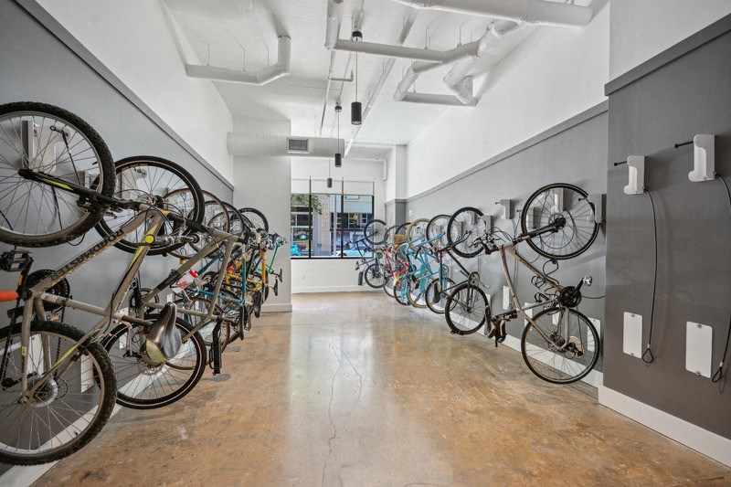 a row of bikes hanging on a wall in a room at Link Apartments® 4th Street, Winston-Salem, NC, 27101