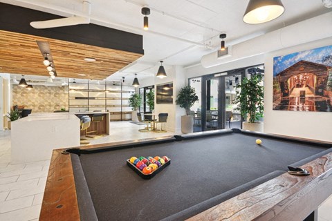 a large room with a pool table in the middle at Link Apartments® 4th Street, Winston-Salem, NC, 27101