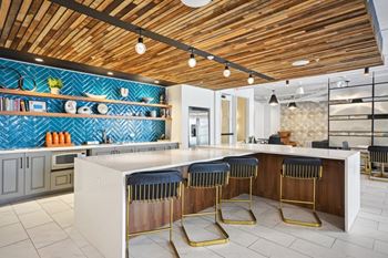 A kitchen with a bar area and a wooden ceiling. at Link Apartments® 4th Street, Winston-Salem, North Carolina