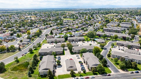 A bird's eye view of a residential area with houses and roads.