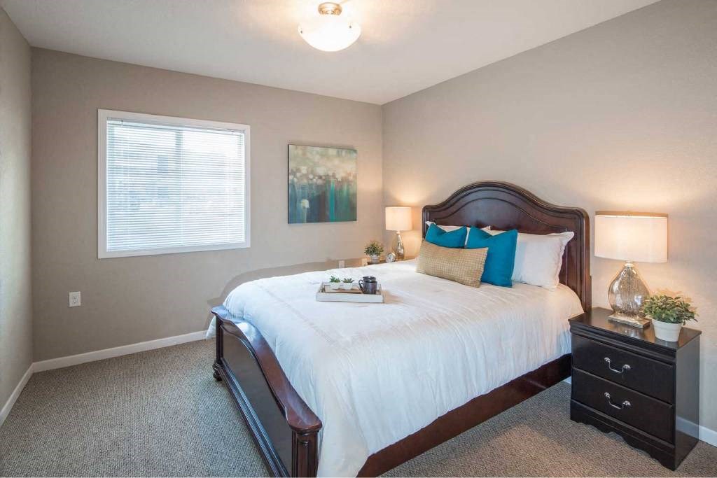 a bedroom with a large bed and a window