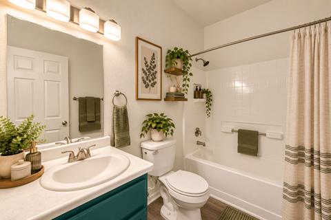 A bathroom with a white toilet, a white sink, and a white bathtub.