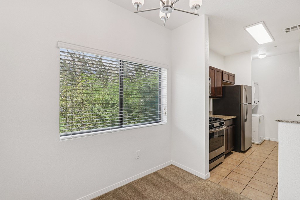 A kitchen area with a refrigerator, oven, and microwave.