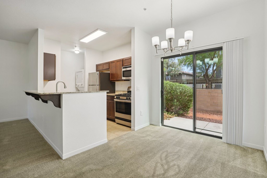 A kitchen with white cabinets and a white island with a countertop.