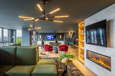 A modern living room with a fireplace and a flat screen TV.