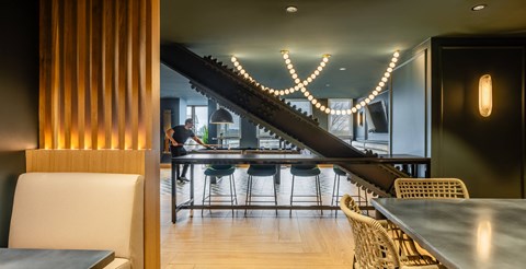 A modern dining area with a long table and chairs.