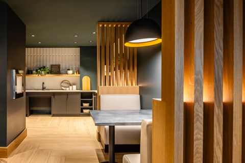 A modern kitchen with a dining table and chairs.