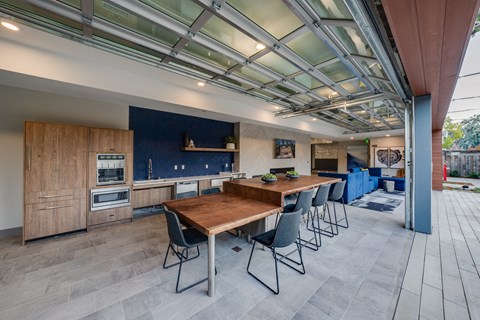 a large kitchen with a long wooden table and chairs