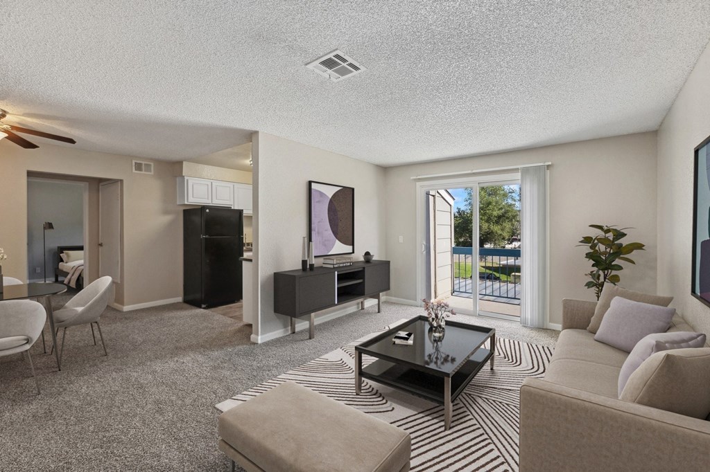 the living room of an apartment with a couch and a coffee table
