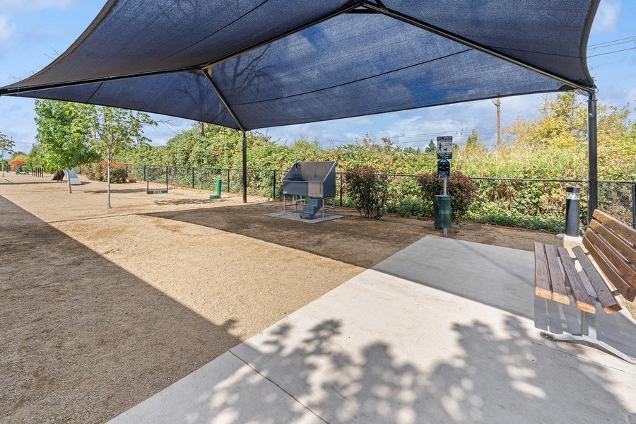 a picnic area with benches and a blue canopy