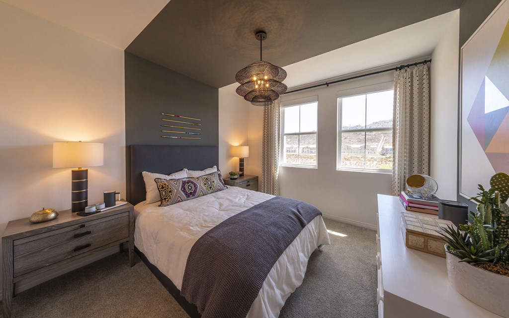 a bedroom with a large bed and a white table