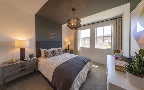 a bedroom with a large bed and a white table