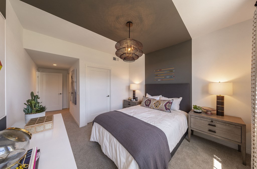 a bedroom with a large bed and a white table