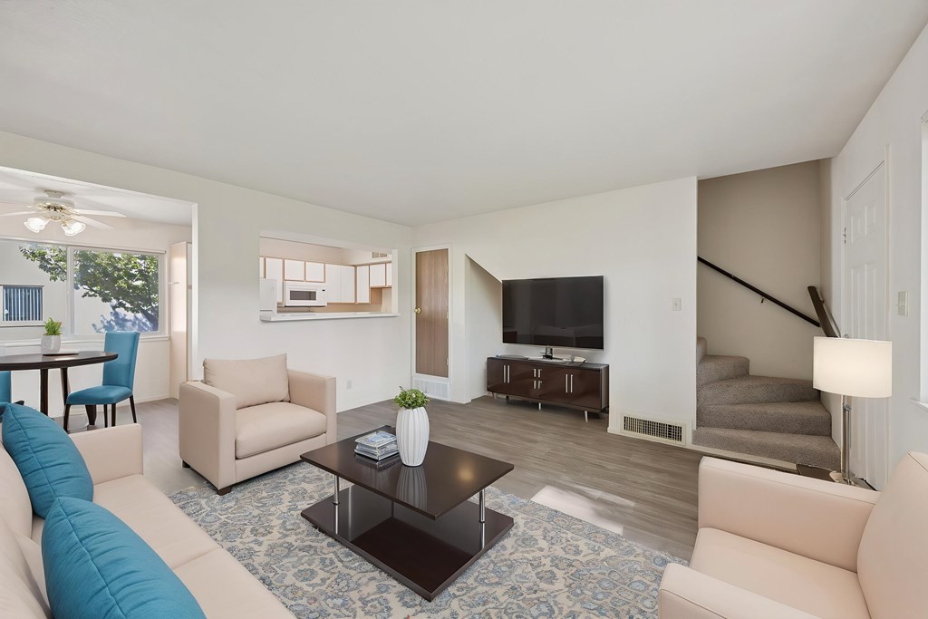 A living room with a blue couch and a television.