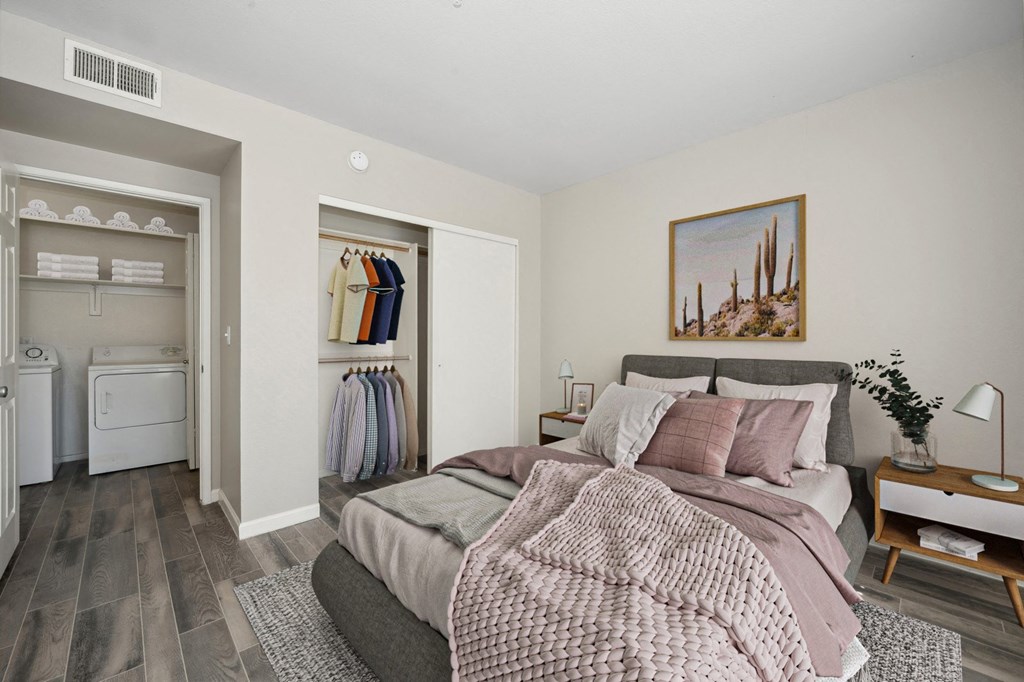 a bedroom with a bed and a closet with a laundry room