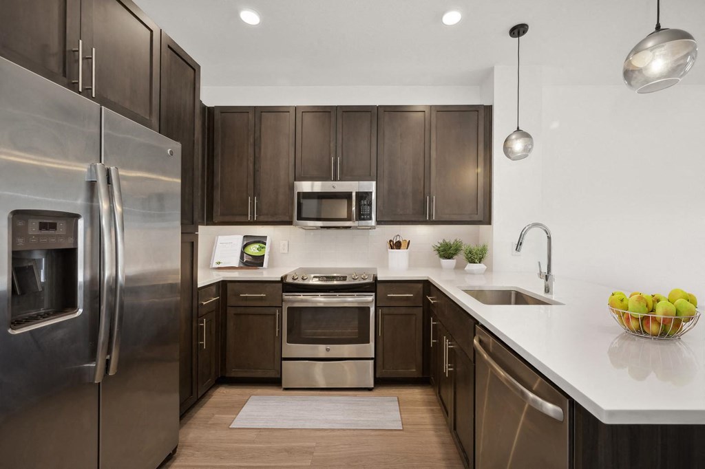 a kitchen with stainless steel appliances and wooden cabinets