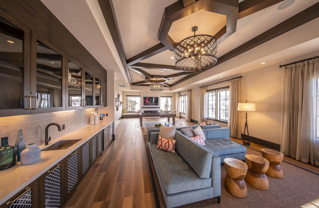 resident lounge with a kitchen and a blue couch