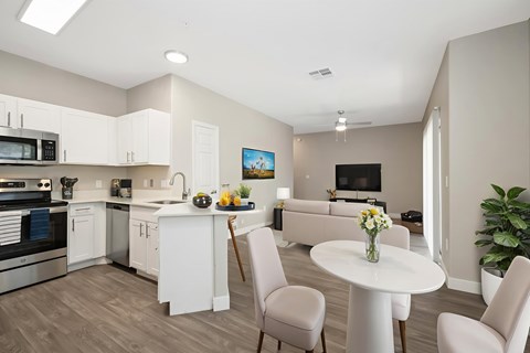 A modern kitchen with a dining table and chairs.