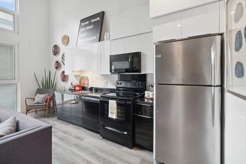 a kitchen with stainless steel appliances and a refrigerator