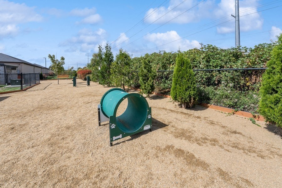 a park with a green playground and trees