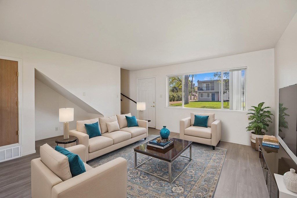 A living room with a couch, chair, and a coffee table.