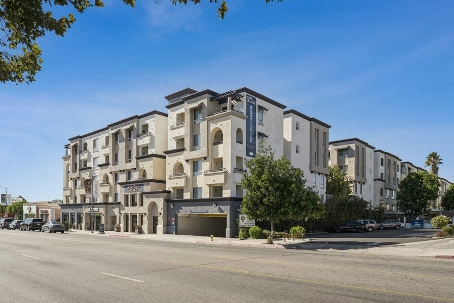 a large apartment building on the corner of a street